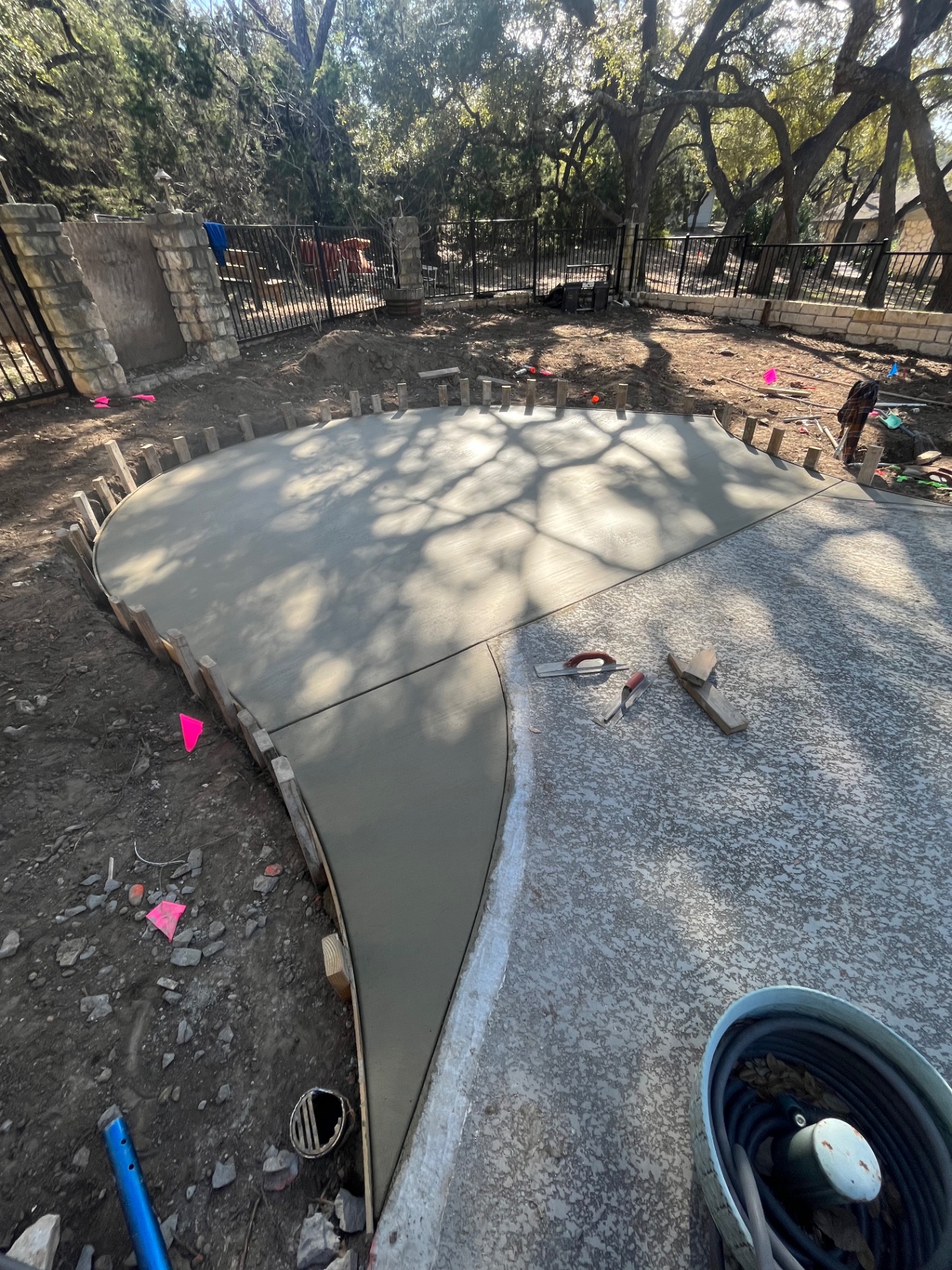 Custom curved concrete pool patio addition with smooth troweled finish
